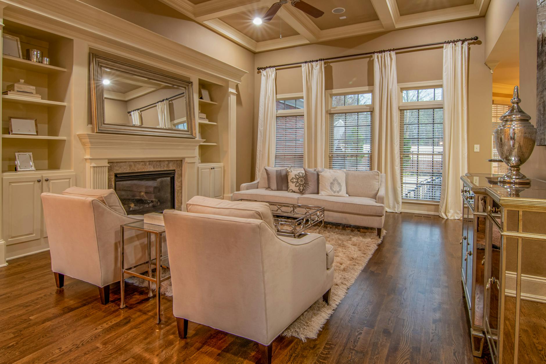 A cozy living-room visual with soft seating, layered light, and warm tones